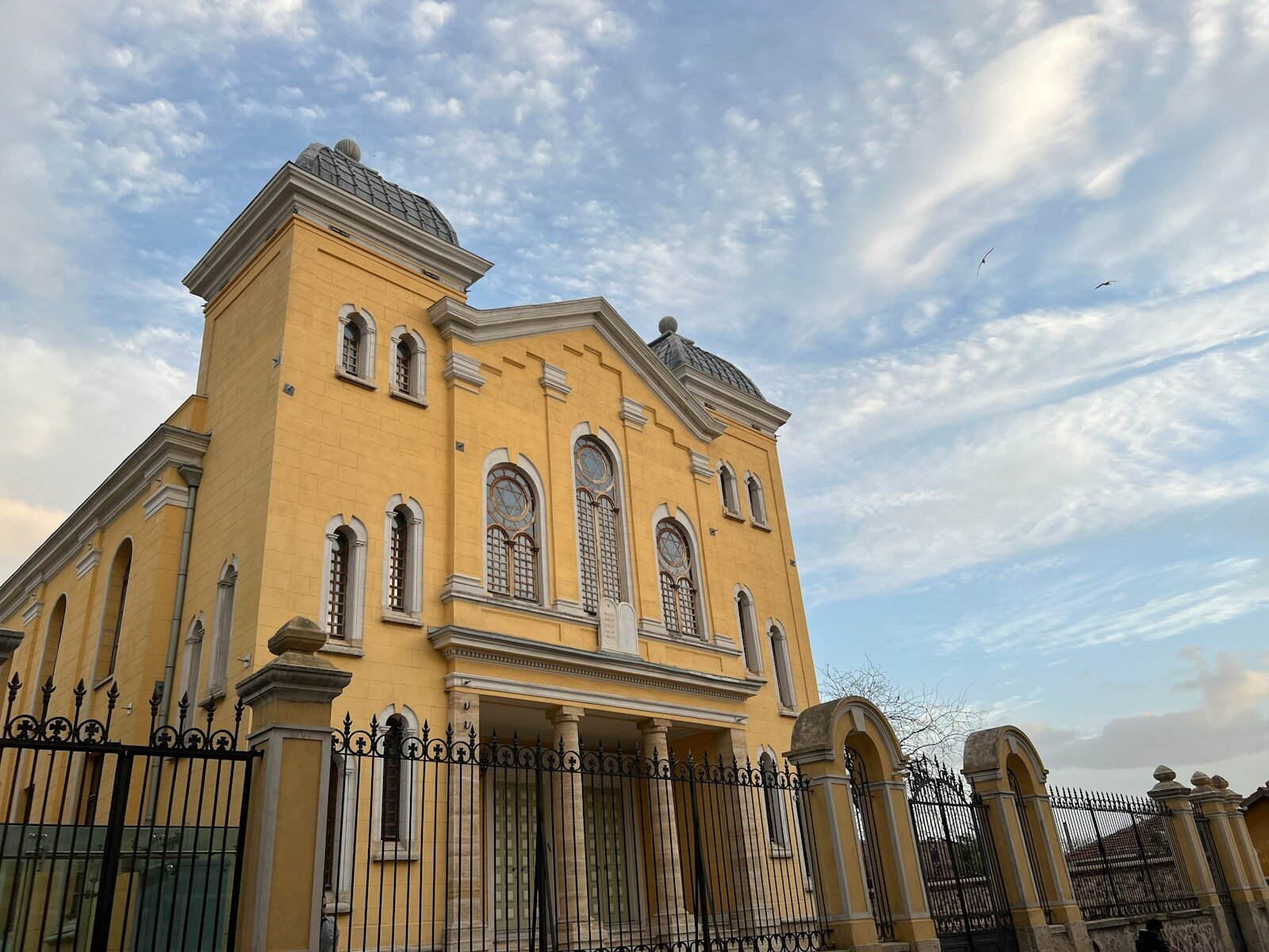 a large building with a fence in front of it