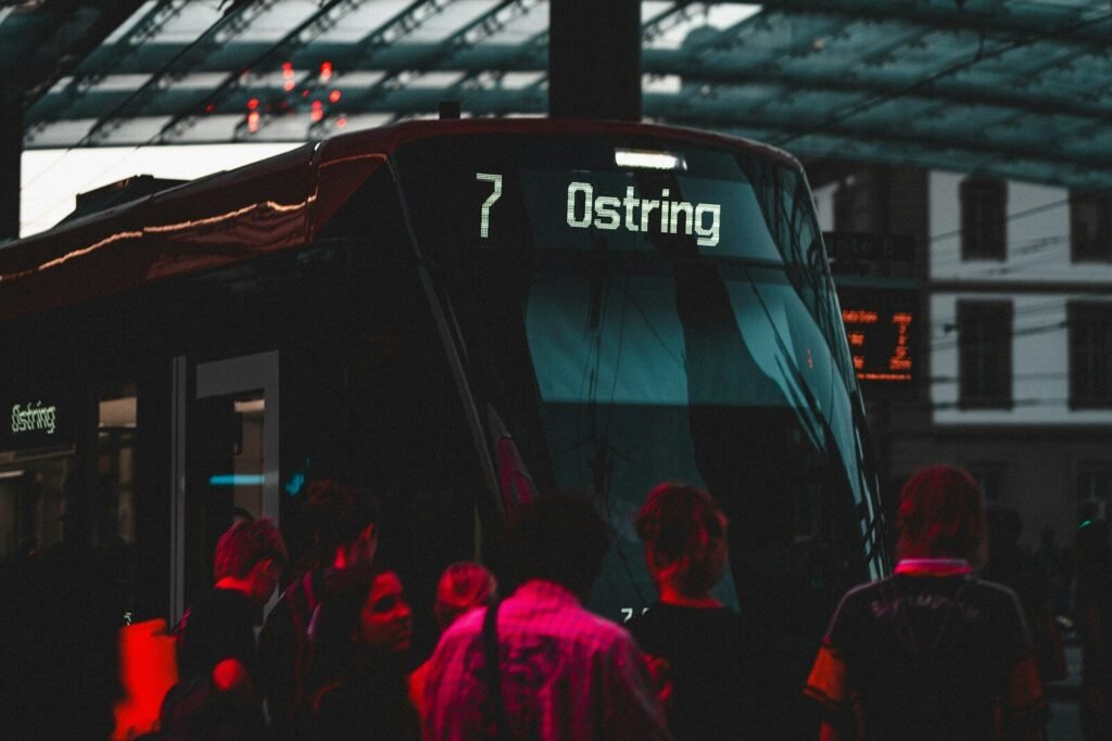 A group of people standing next to a bus