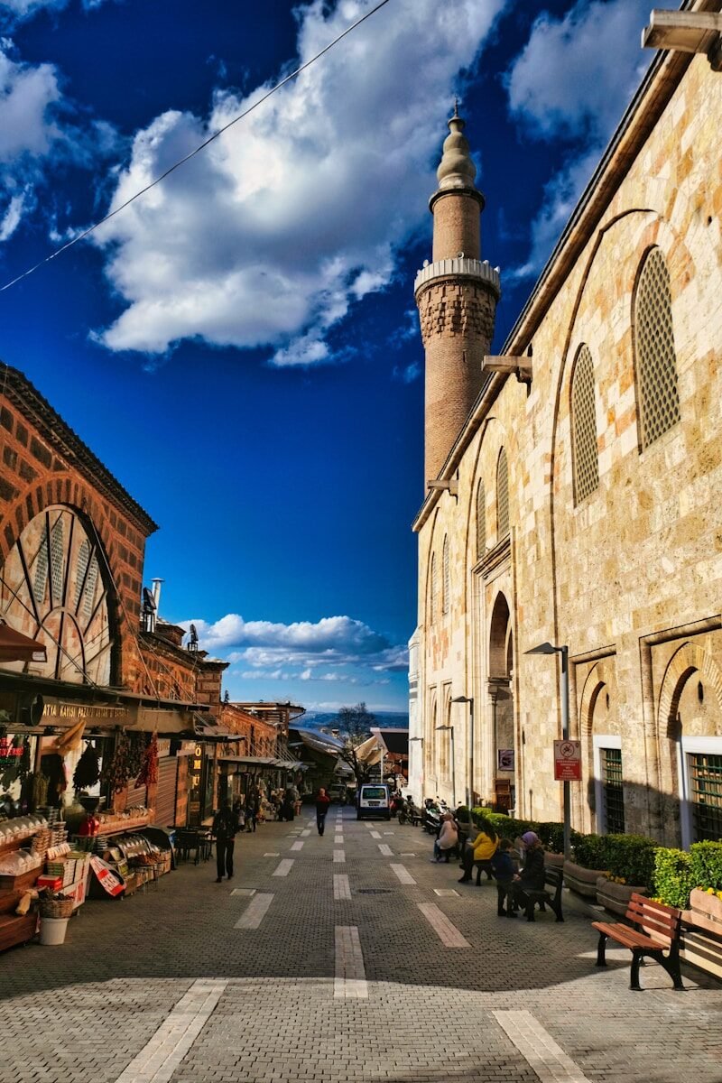 a street lined with buildings and a tall tower