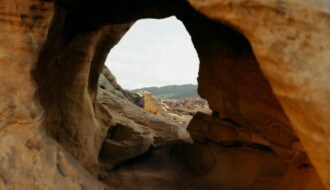 View through a rock arch at a desert landscape