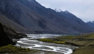 a river running through a lush green valley