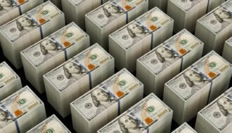 Stacks of hundred dollar bills are shown.