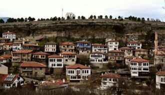 A city with lots of houses on top of a hill