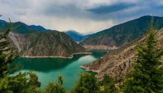 photo of mountain and body of water