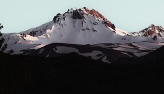 Snow-capped mountain peak under a clear sky.