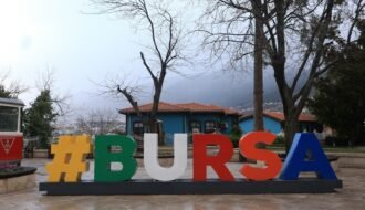 The sign says "#bursa" in a park.