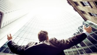 low-angle photography of man in the middle of buidligns