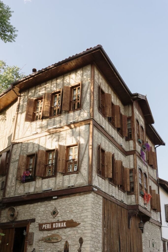 Charming traditional house featuring wooden shutters and stone facade, ideal for travel and architecture themes.