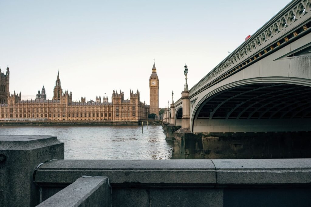 View of Big Ben and Westminster Bridge at dusk in London, England, UK.