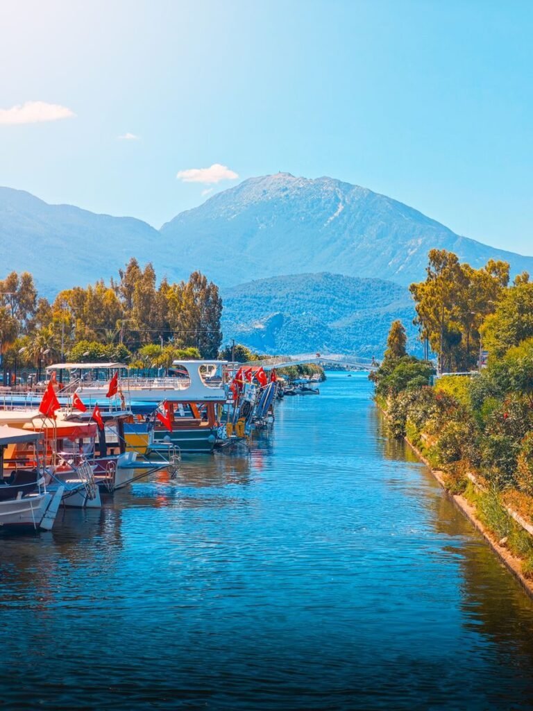 Beautiful view of boats and mountains along a river in Fethiye, Turkey.