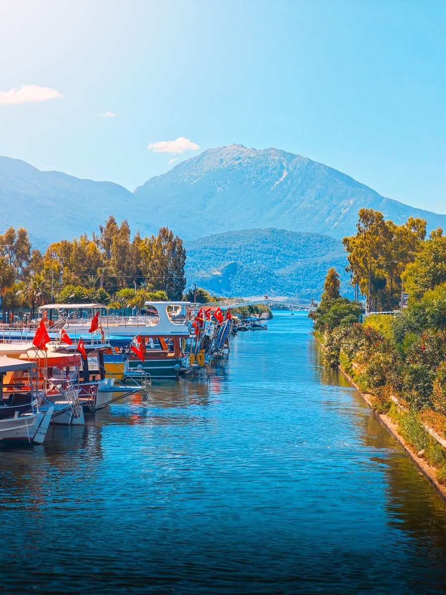 Beautiful view of boats and mountains along a river in Fethiye, Turkey.
