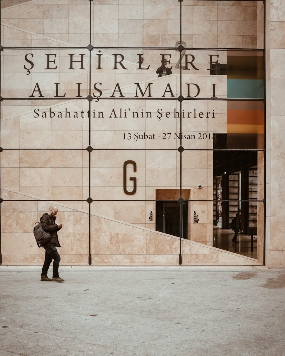man walking beside structure