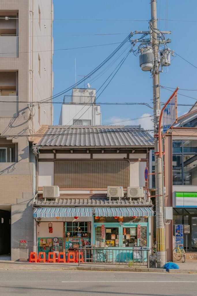 Small storefront with traditional japanese architecture and air conditioners.