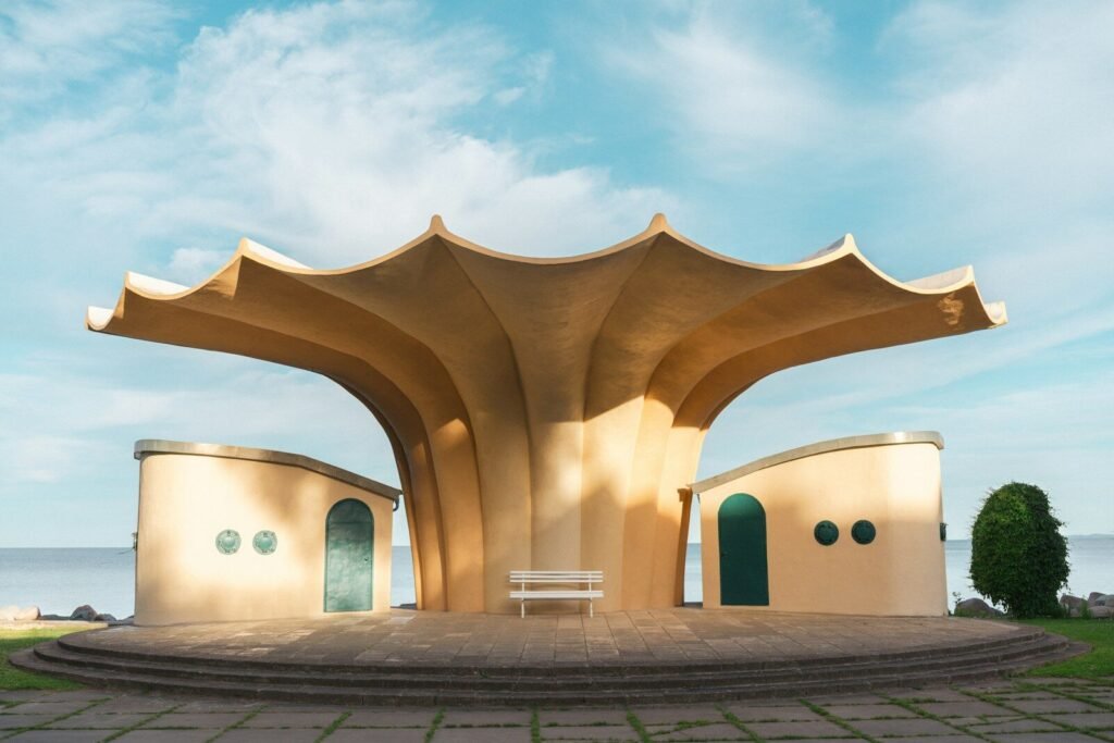Modern shell-shaped concrete pavilion by the sea.