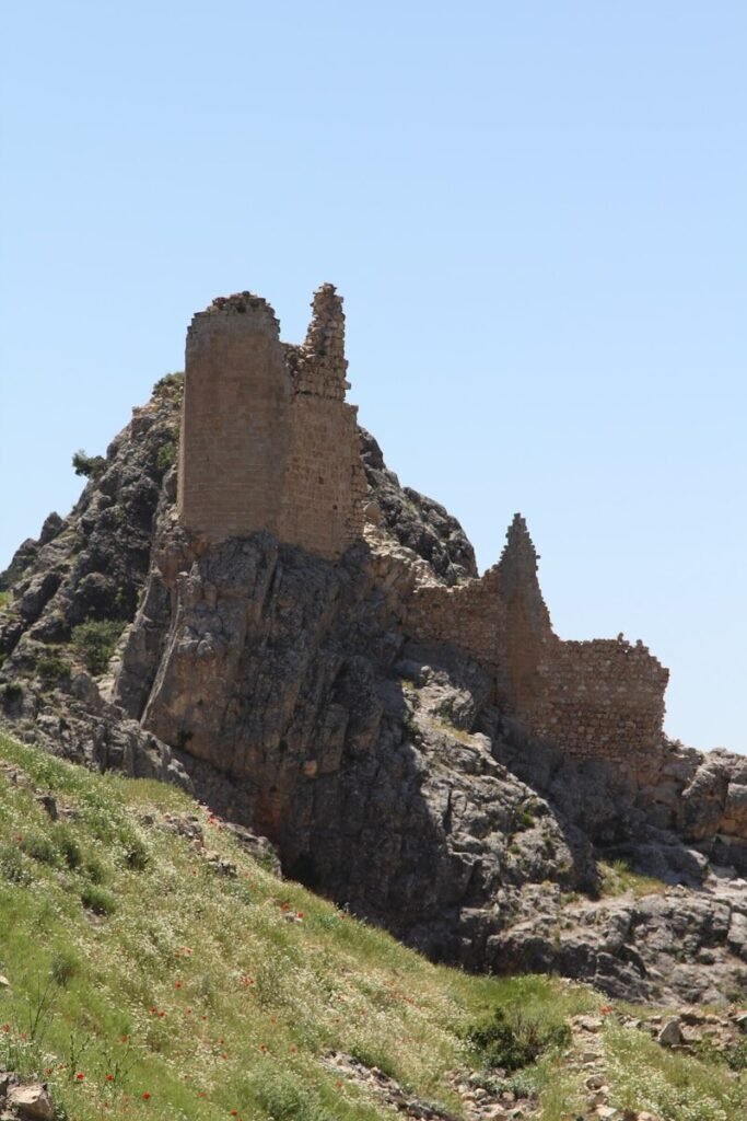 an old castle on top of a rocky hill