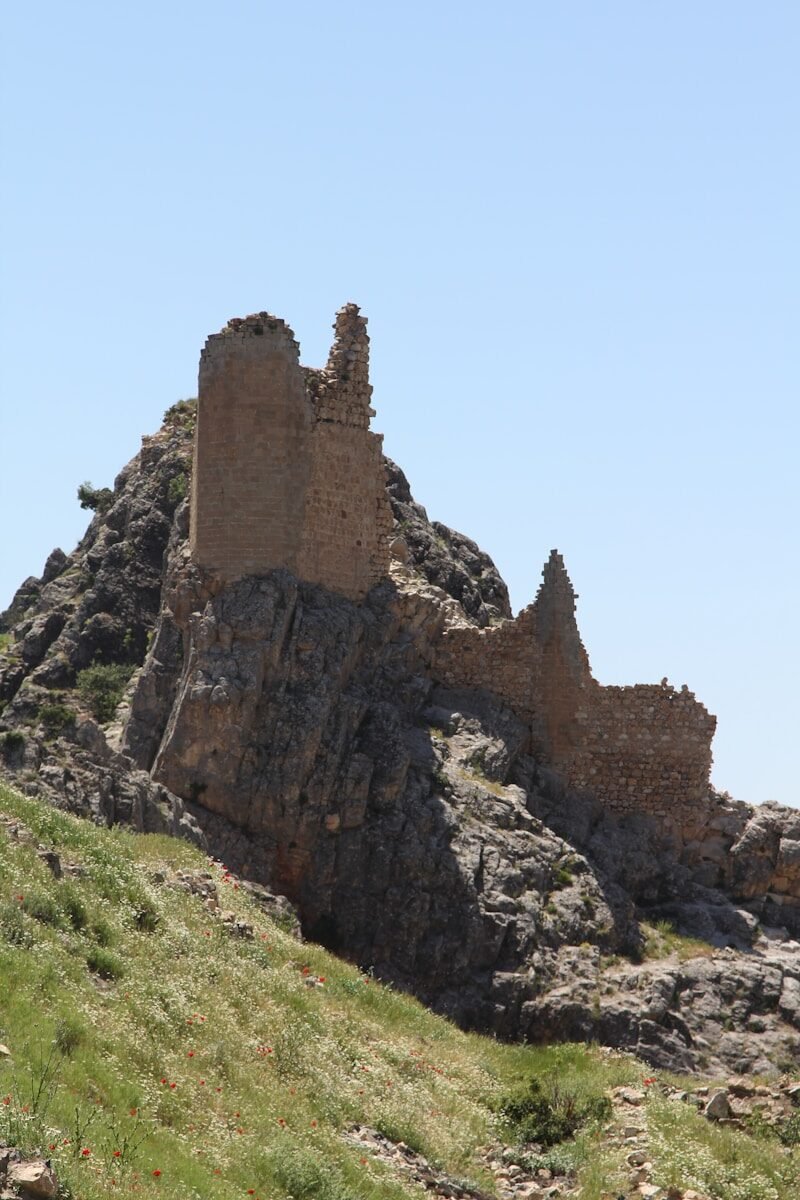 an old castle on top of a rocky hill
