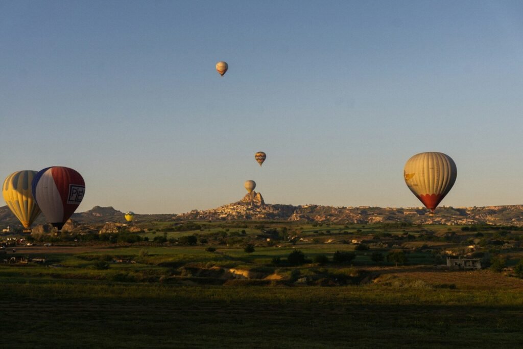 a group of hot air balloons flying in the sky