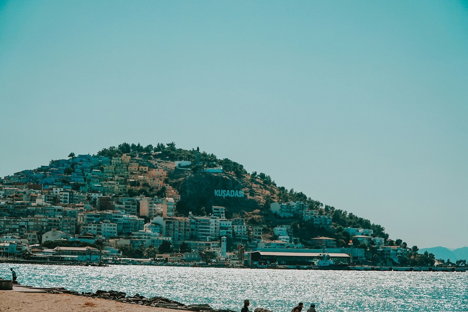 city buildings near body of water during daytime